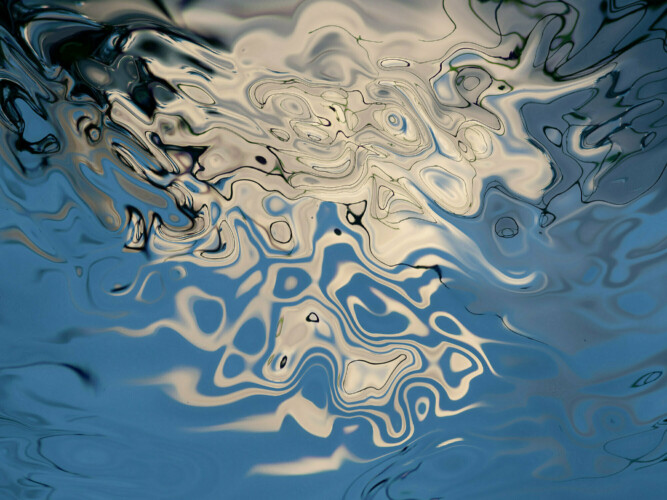 white and blue abstractions with many shades of blue and tones of white in a fluid floating pattern.